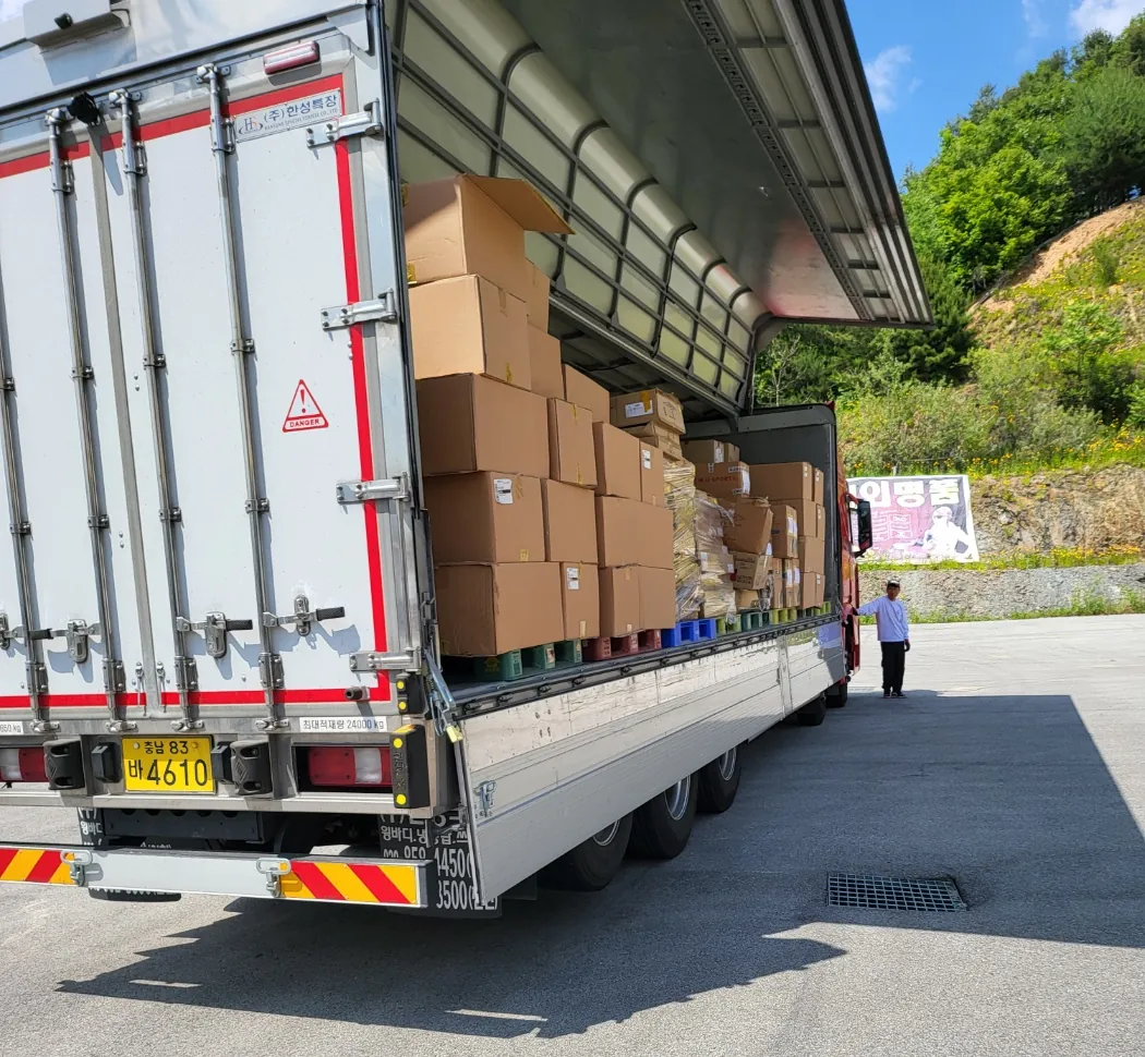 A curtain-side trailer being loaded with palletised cartons