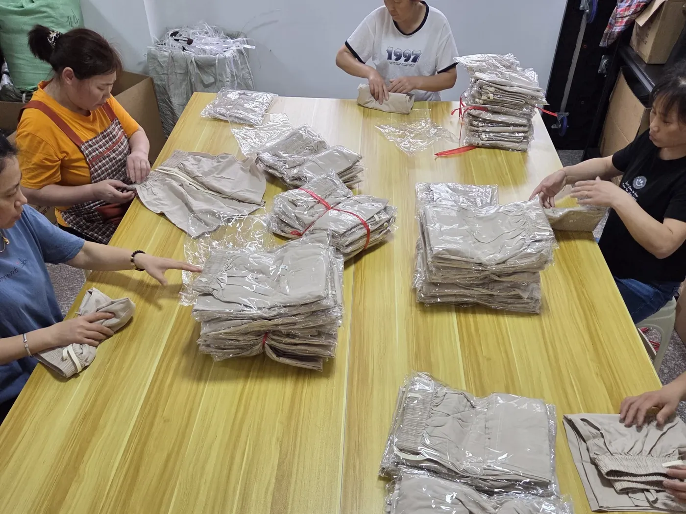 Our team bagging and boxing finished garments before dispatch