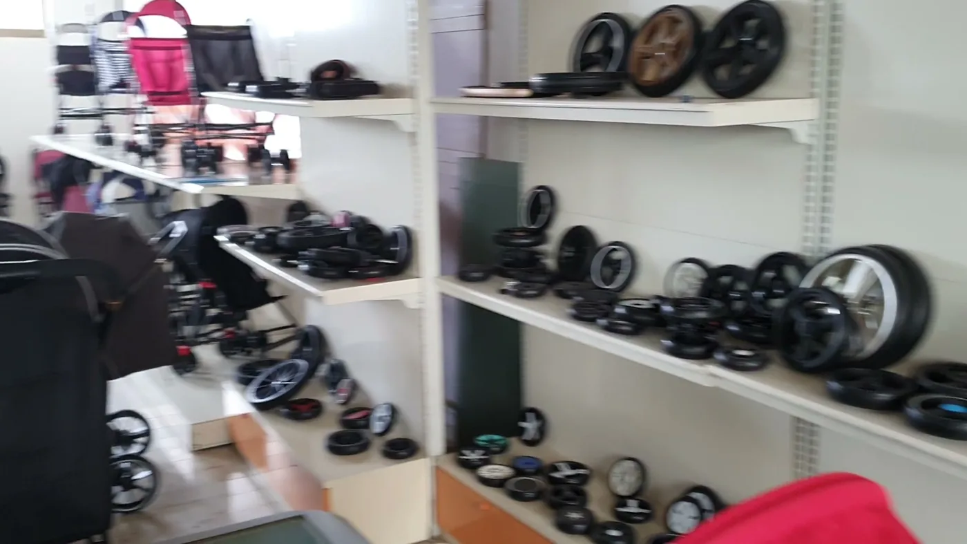 Stroller wheels, frames and components racked at a production site in China