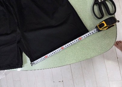 Shorts length measured against a tape